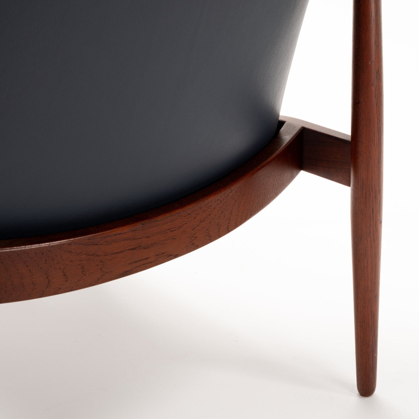 Jacob Kjaer Adjustable Lounge Chair close detail showing black leather upholstery joined to a curved dark rosewood frame and tapered leg in mid century modern furniture style