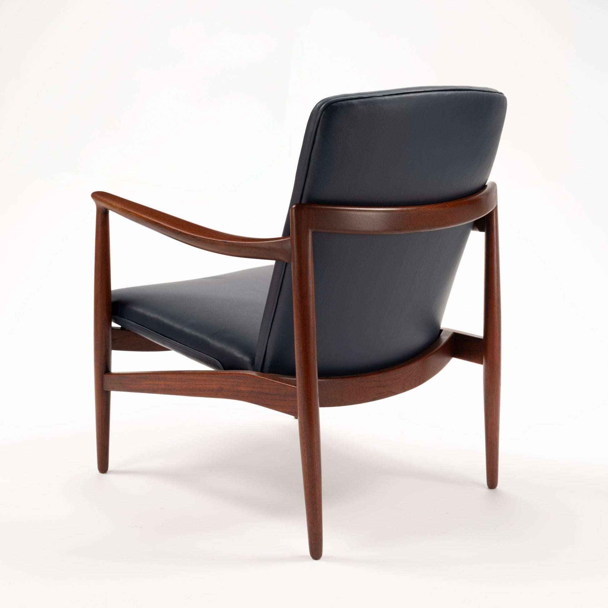 Jacob Kjaer Adjustable Lounge Chair rear three quarter view with black leather upholstery curved rosewood frame and tapered legs in vintage danish furniture style