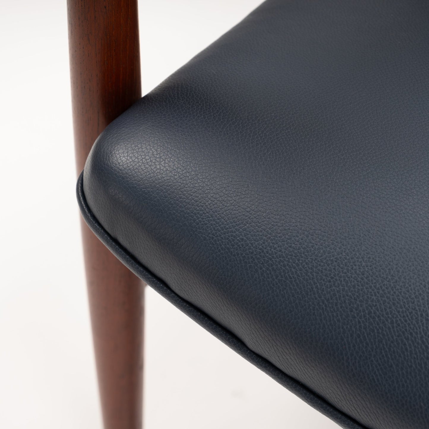 Jacob Kjaer Adjustable Lounge Chair close detail of textured black leather cushion and polished rosewood support in mid century modern furniture style