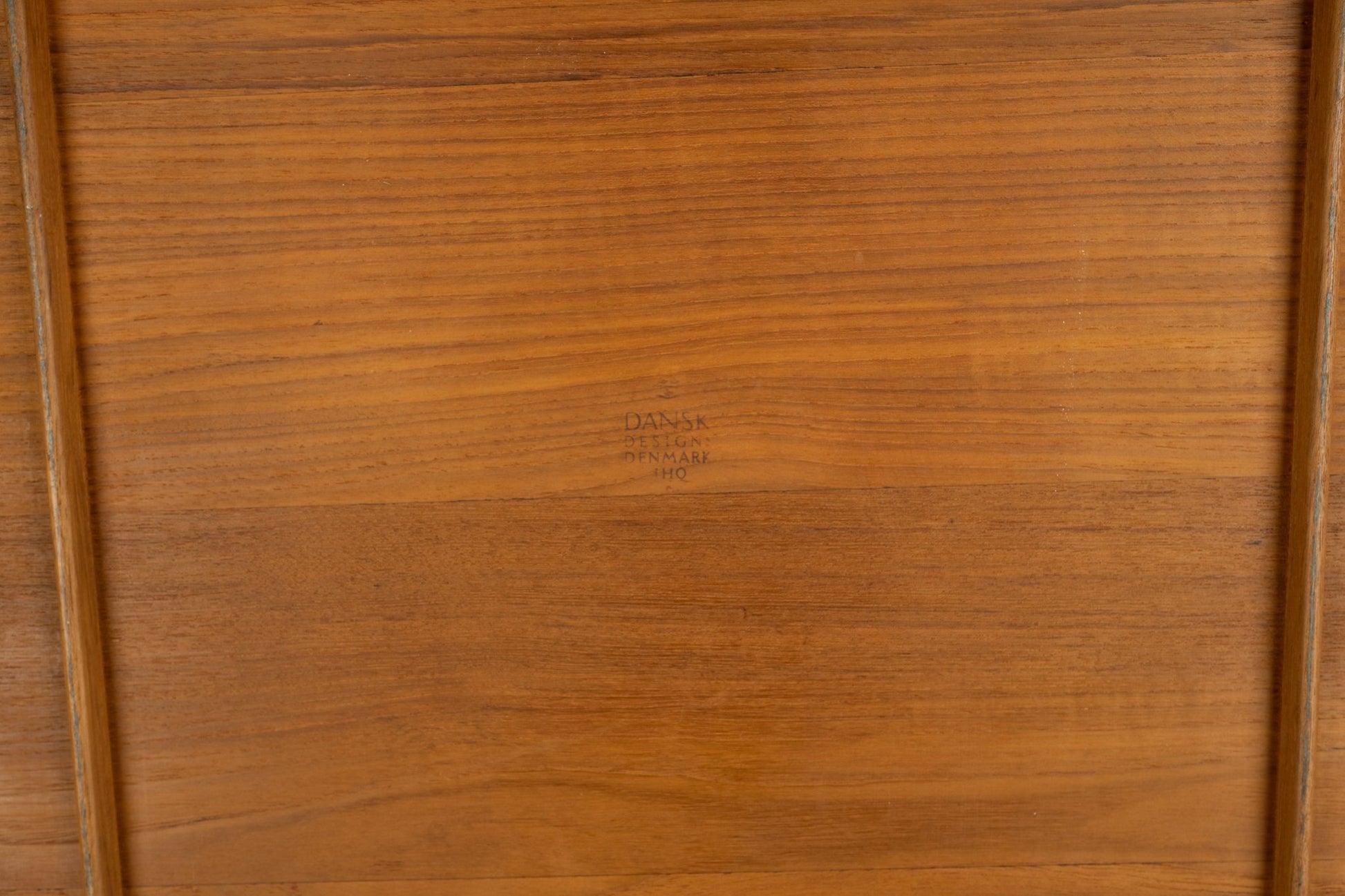 Underside of Jens Quistgaard 1950s oval teak tray with Dansk Denmark four ducks logo branding visible