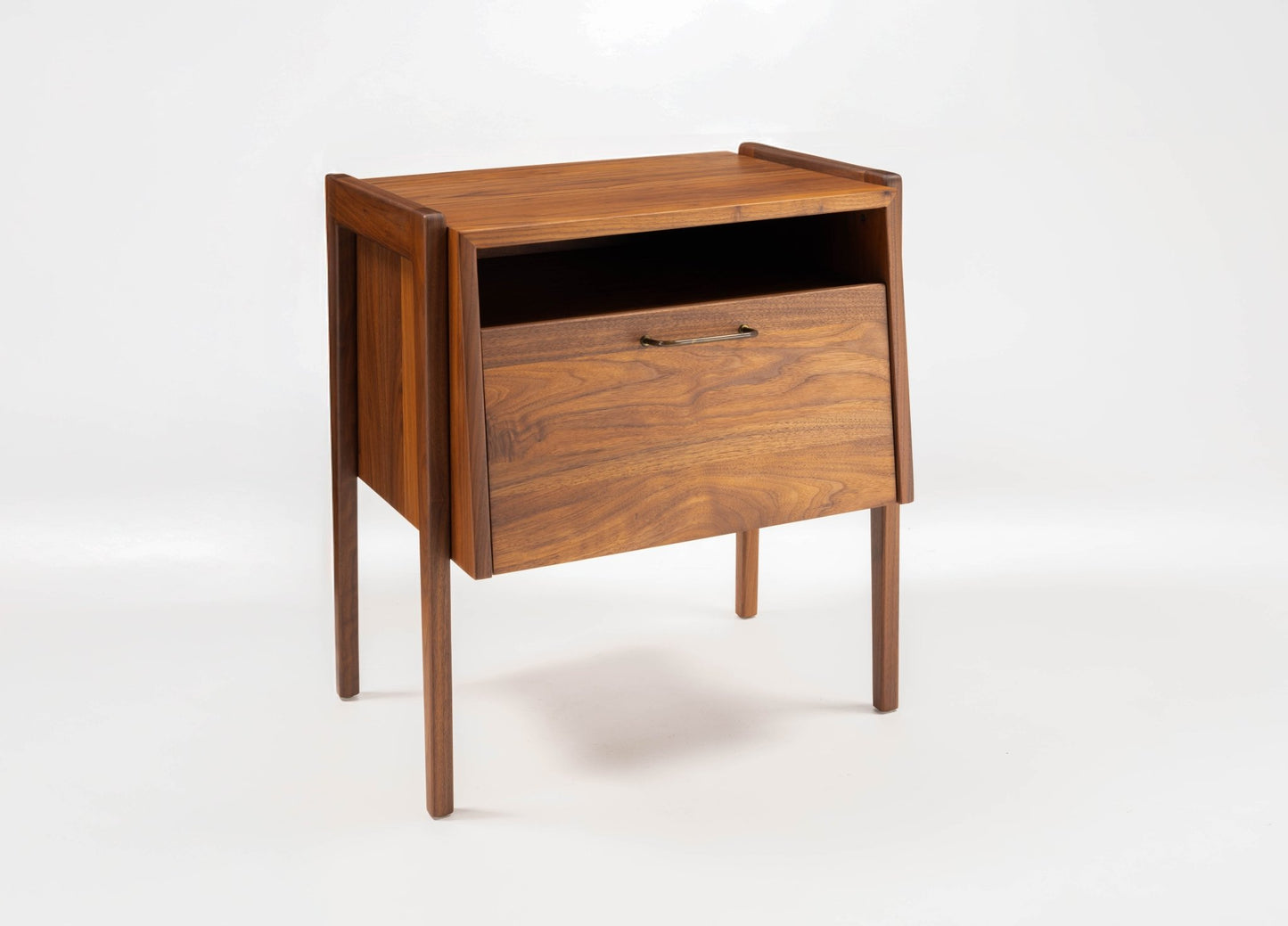 Mid-century modern Jens Risom walnut bedside table with open compartment and fall-front drawer on tapered legs.