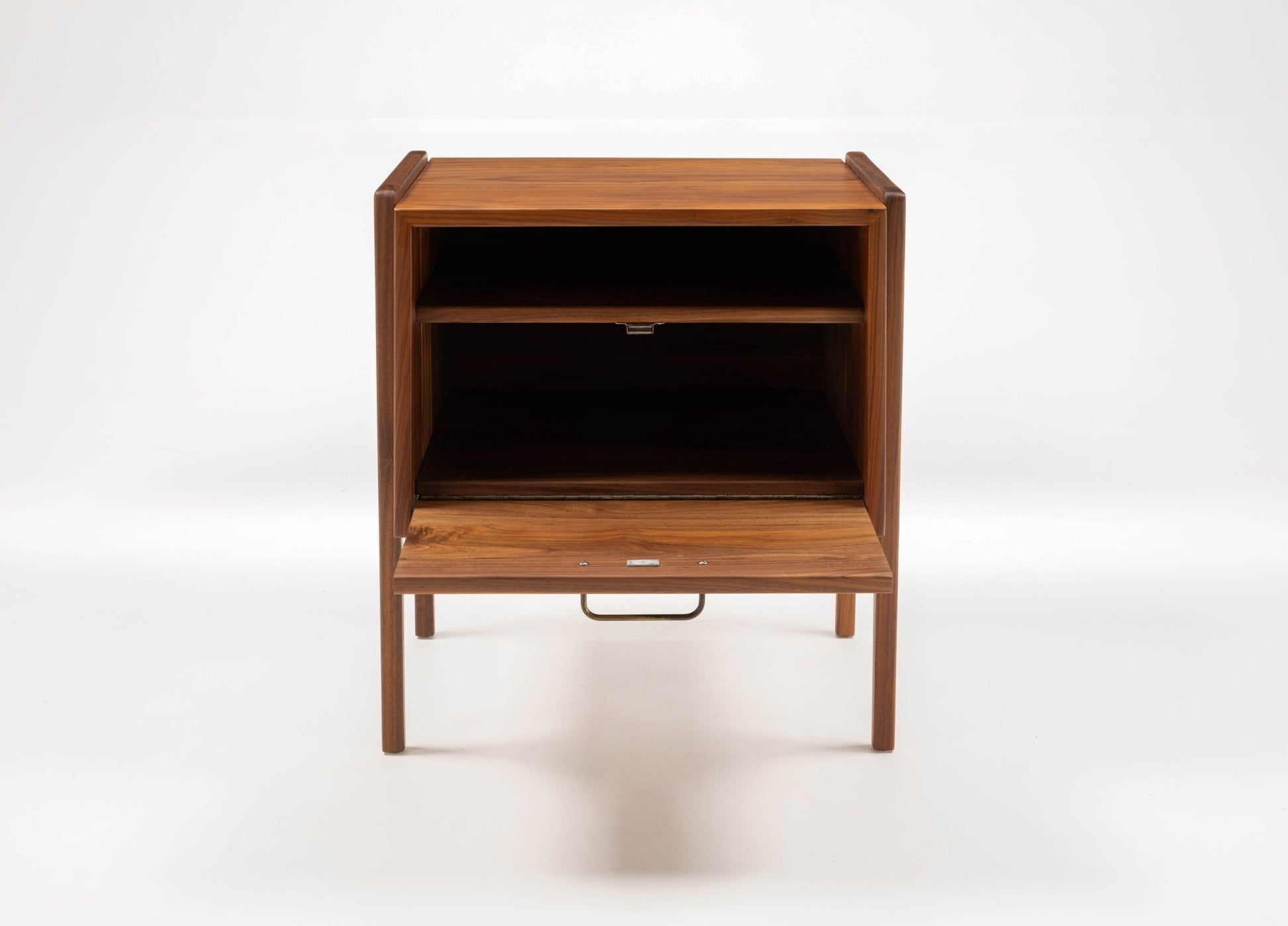 Pair of mid-century modern walnut Jens Risom bedside tables with open shelf and fall-front drawer, circa 1960s.