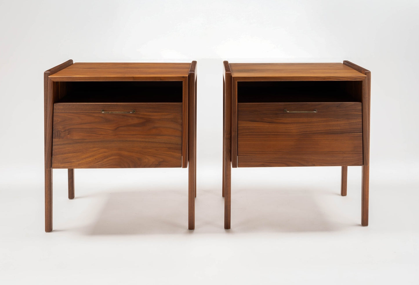 Pair of 1960s Jens Risom walnut bedside tables with open compartments and fall-front drawers on slender legs