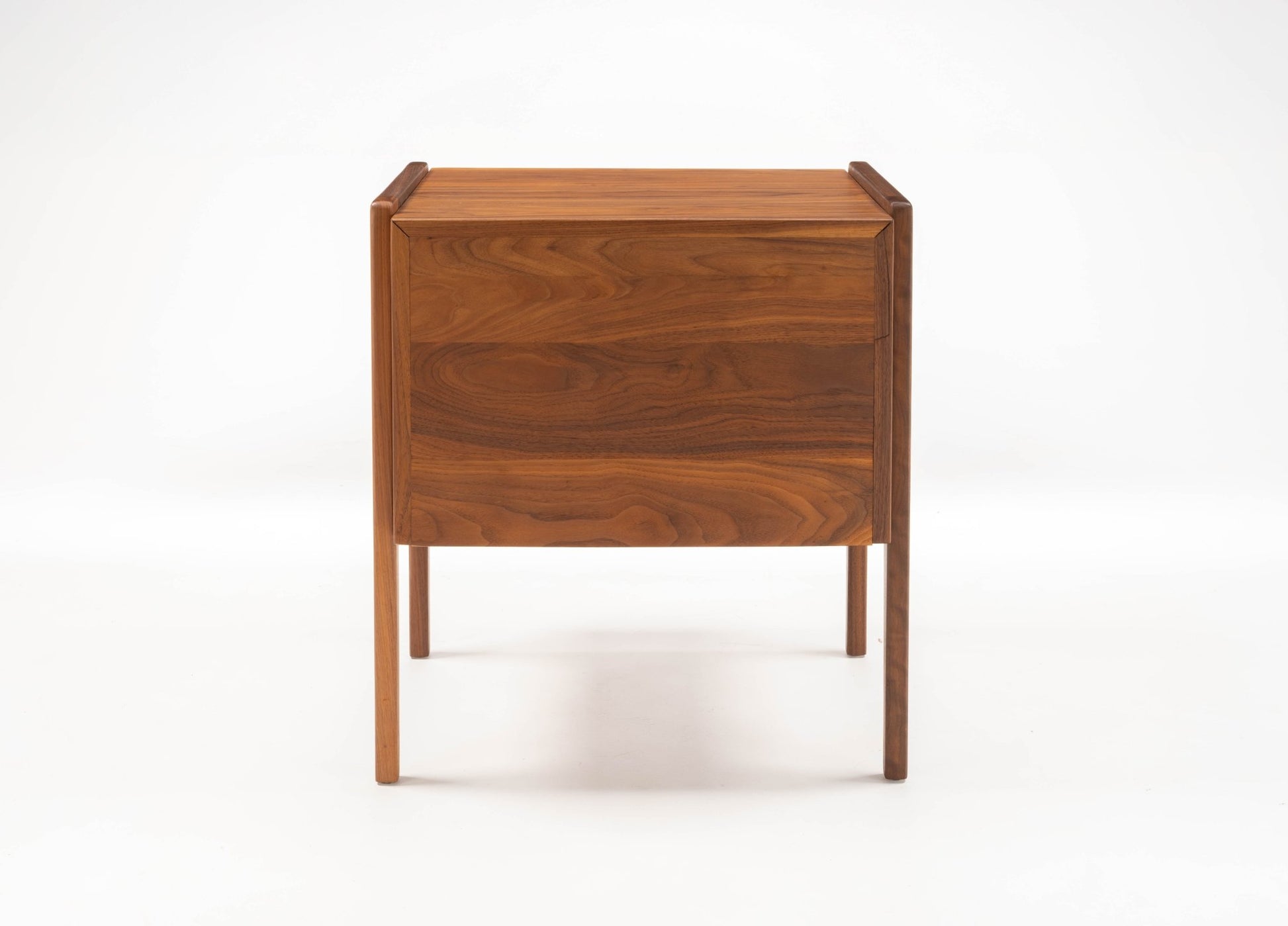 Pair of mid-century modern walnut bedside tables with fall-front drawers and open compartments on tapered legs.