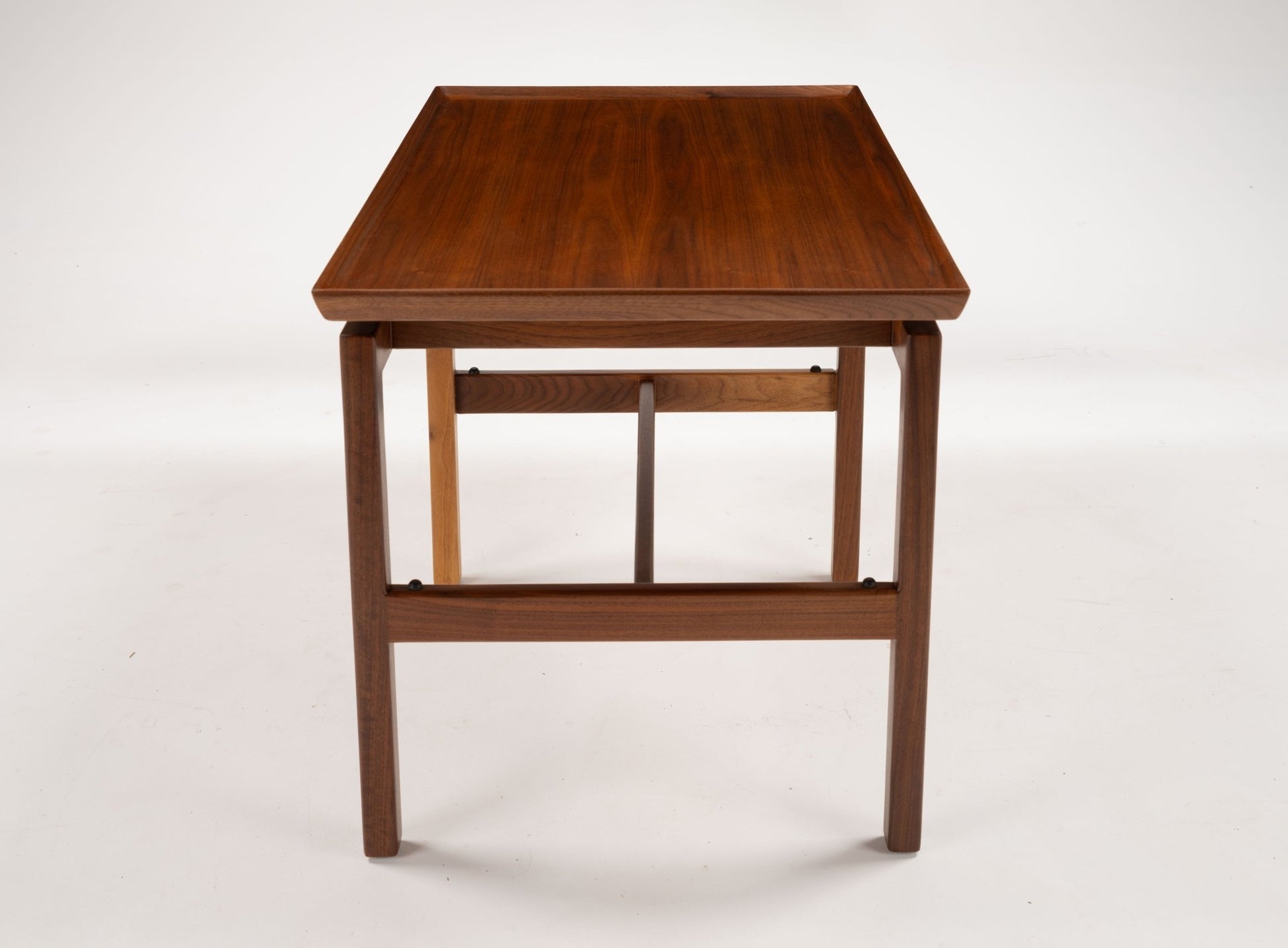 Mid-century modern Jens Risom cantilever side table in rich walnut with rectangular top and wooden frame