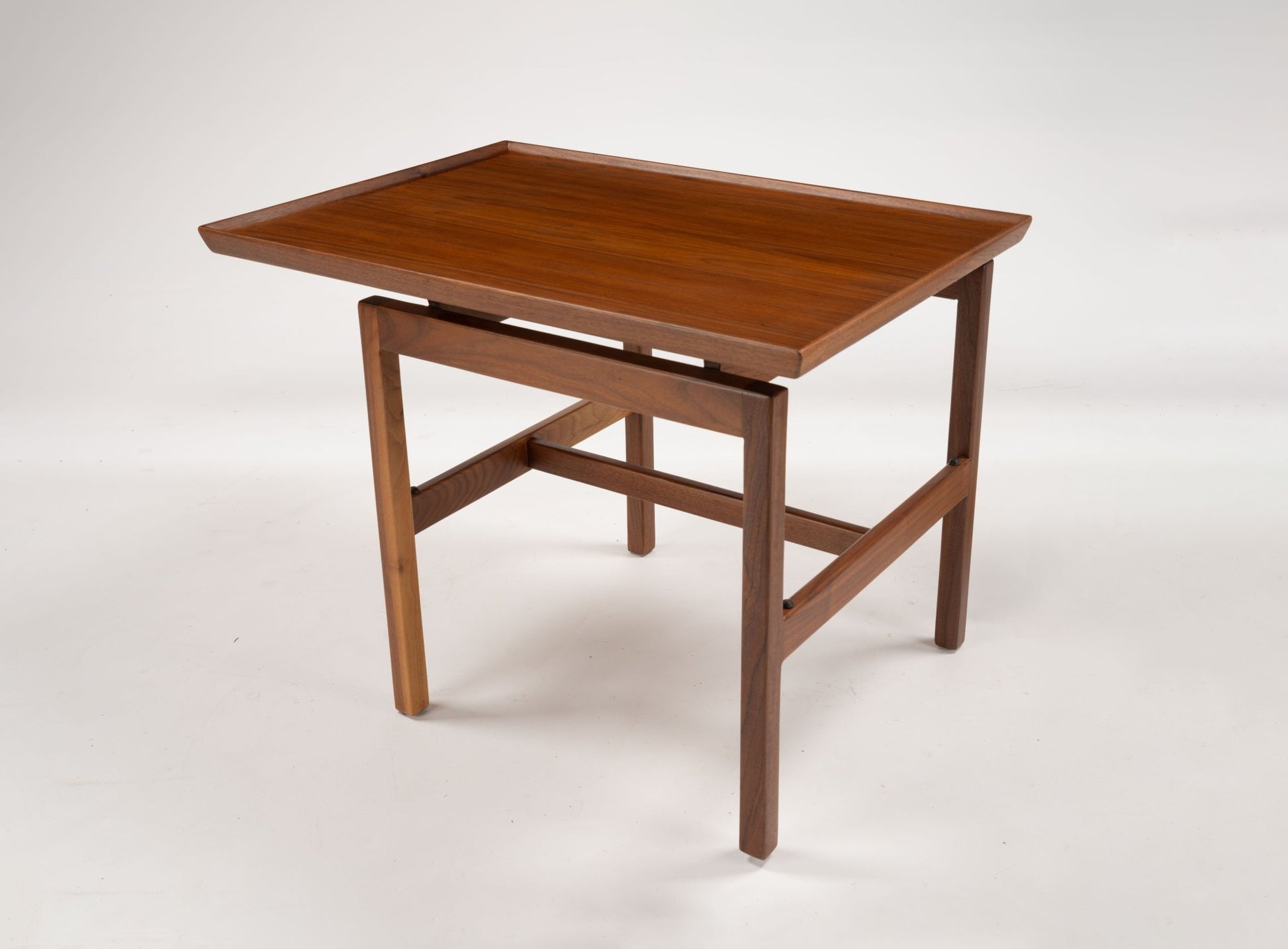 Mid-century modern Jens Risom walnut cantilever side table with rectangular top and gallery edge on four legs