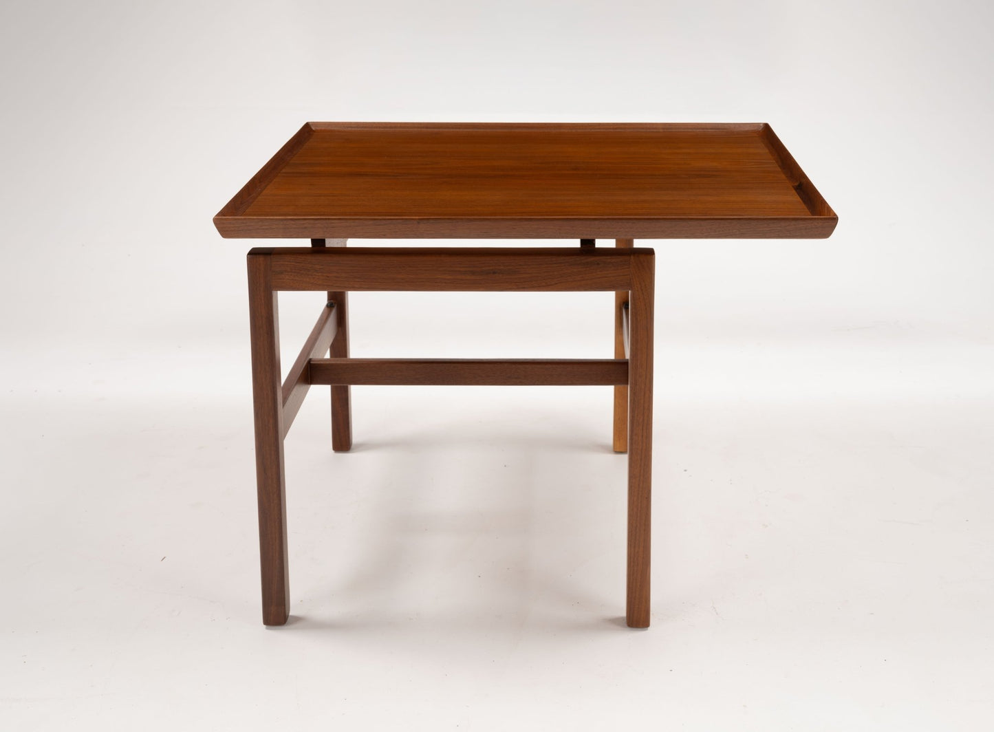Mid-century modern walnut cantilever side table with off-center rectangular top and gallery edge on angled legs