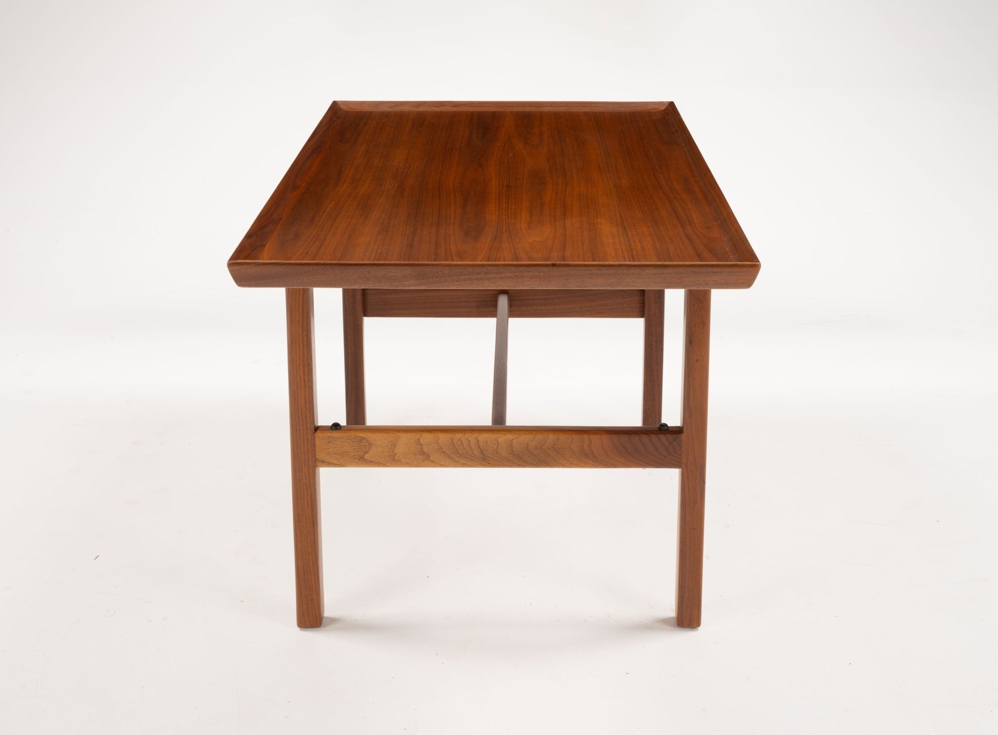 Mid-century modern Jens Risom cantilever side table in walnut with rectangular top and minimalist wood frame
