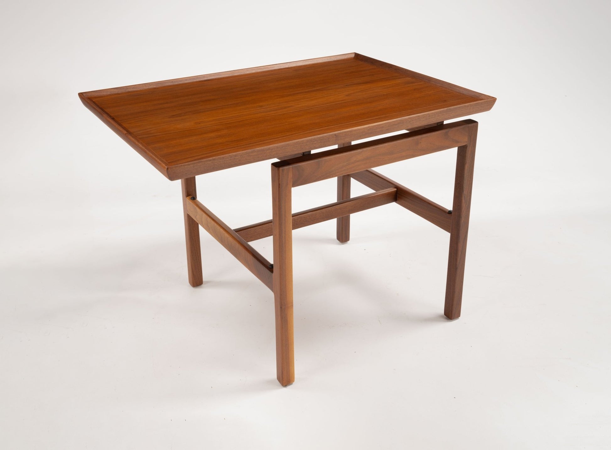 Mid-century modern Jens Risom cantilever side table in rich walnut with off-center rectangular top and gallery edge