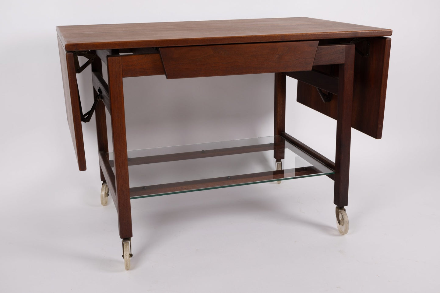 1960s Jens Risom expandable rolling serving cart with wooden leaves and glass lower shelf on casters