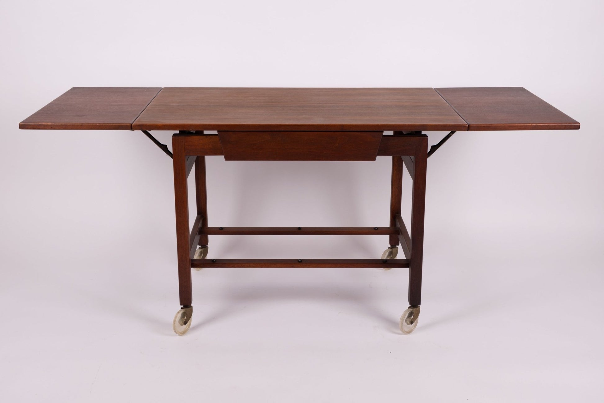 Mid-century Jens Risom expandable wooden serving cart on casters with side leaves extended from the 1960s.