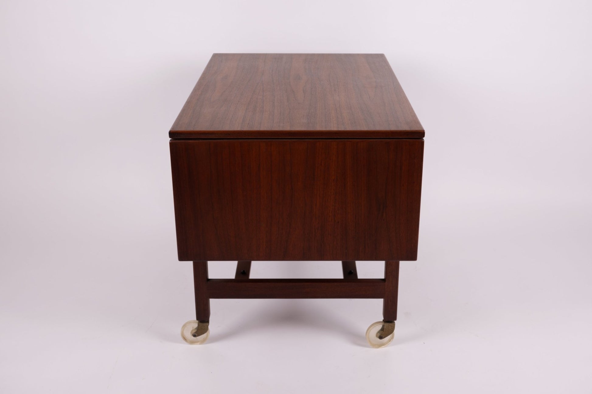 1960s Jens Risom expandable serving cart with walnut finish and casters, shown with leaves folded down