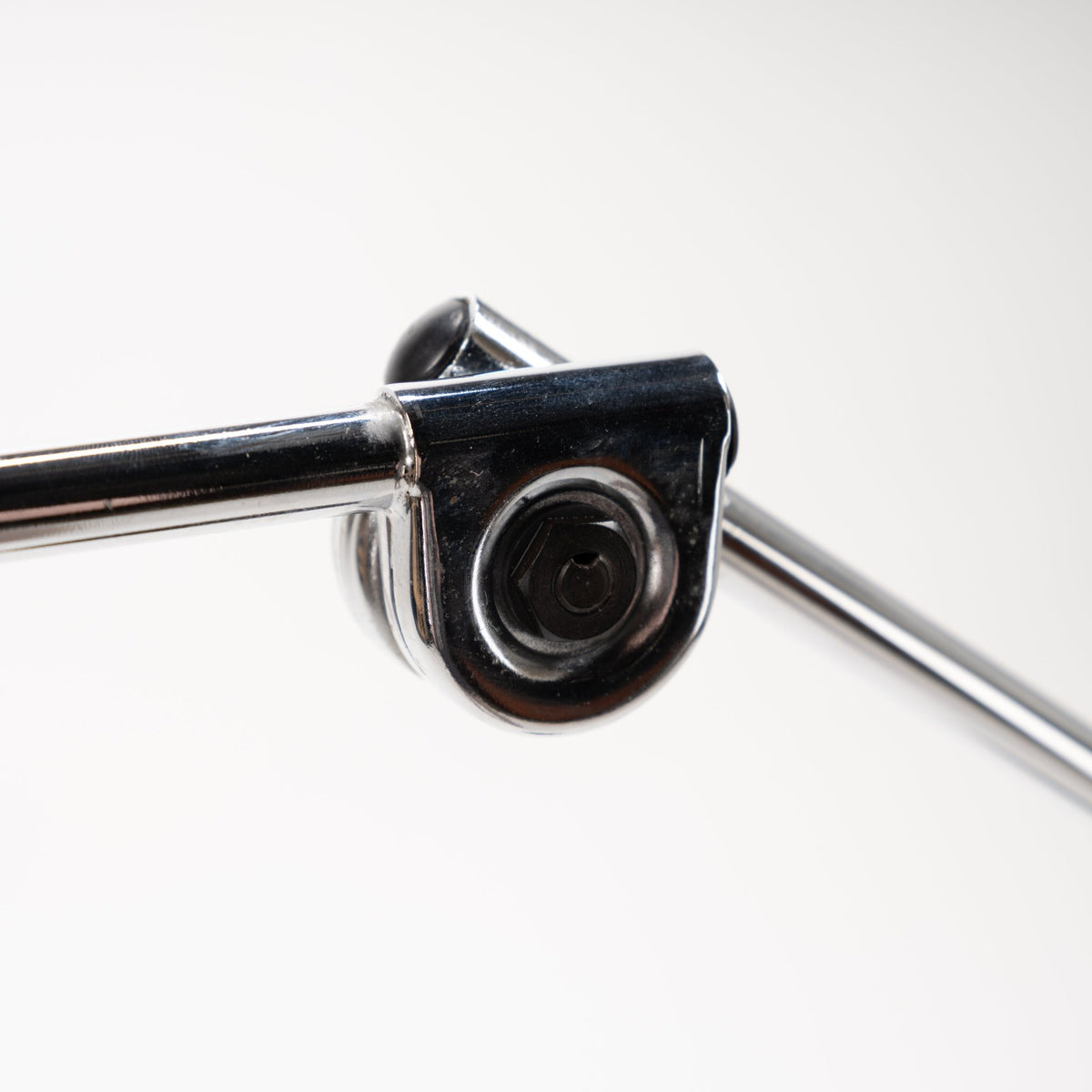 Joe Colombo Chrome Topo Floor Lamp closeup of glossy black pivot housing with polished chrome articulated arms in mid century modern lighting