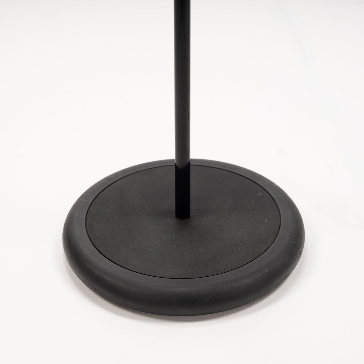 Joe Colombo Chrome Topo Floor Lamp closeup showing its round black weighted base and slim vertical stem in minimalist mid century modern lighting design