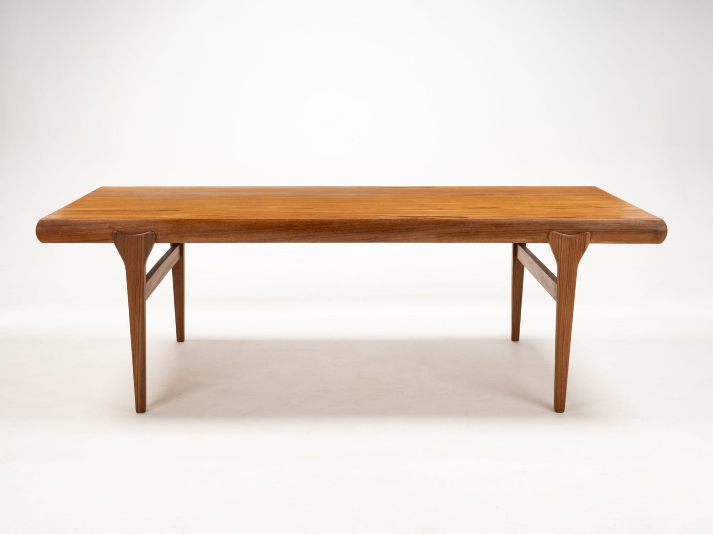 Rectangular teak coffee table with rounded edges and tapered legs showcasing Danish mid-century style craftsmanship