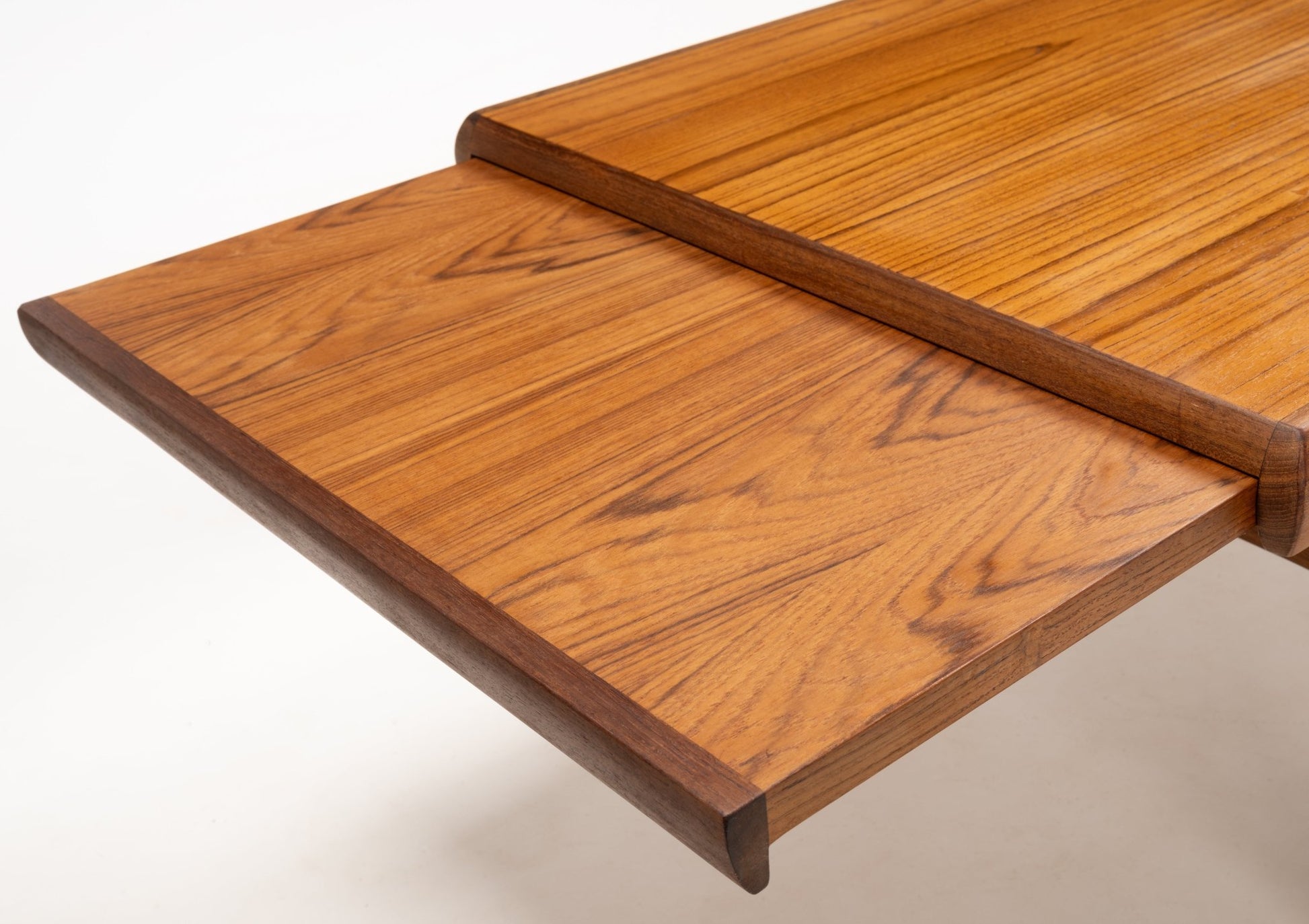 Extended teak tabletop panel with chamfered edges highlighting Danish mid-century woodworking craftsmanship