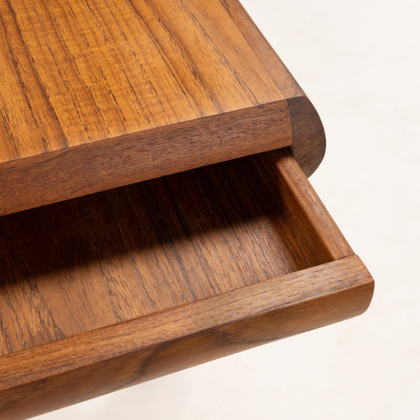 Detail of teak storage drawer and smooth rounded edge on Johannes Andersen mid-century coffee table