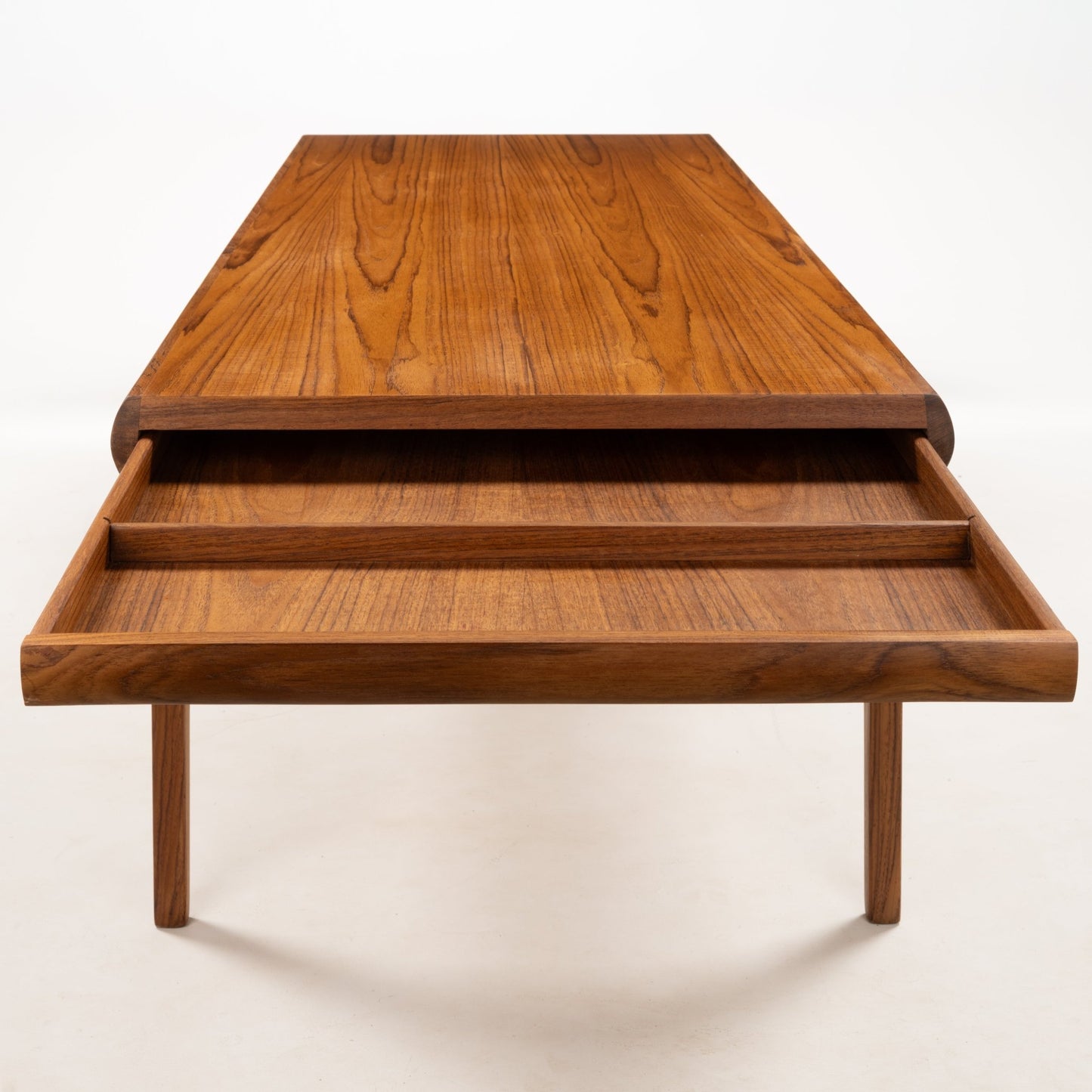 Johannes Andersen teak coffee table with open drawer showing smooth wood grain and minimalist mid-century Danish design