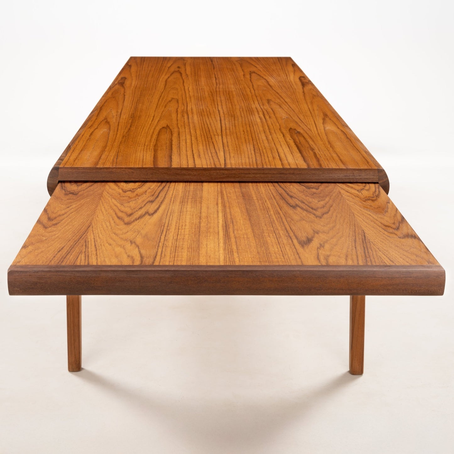 Rectangular teak coffee table with rounded edges and an extended top showcasing Danish mid-century design craftsmanship