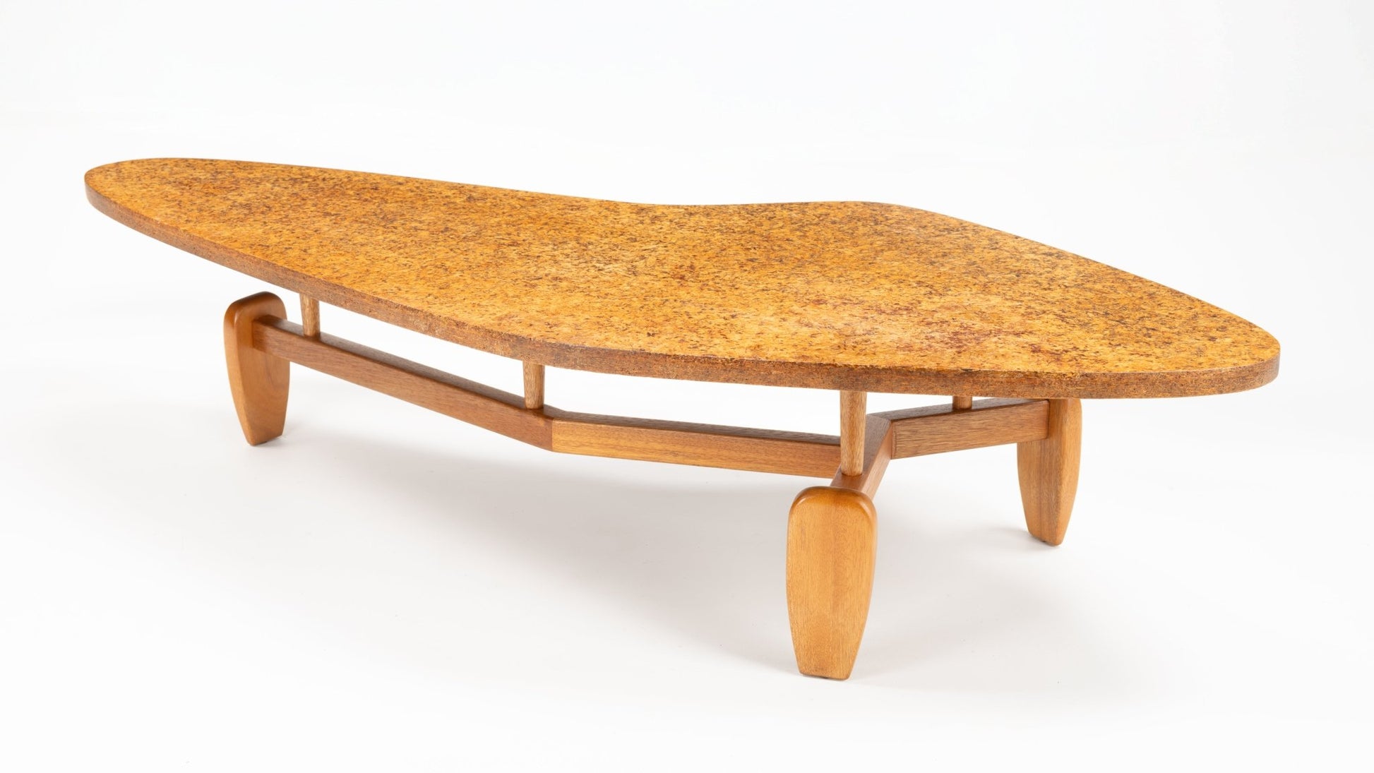 John Keal 'Outrigger' Coffee Table with a distinctive asymmetrical cork top and a sleek wooden base featuring sculptural legs, exemplifying mid century modern furniture design.
