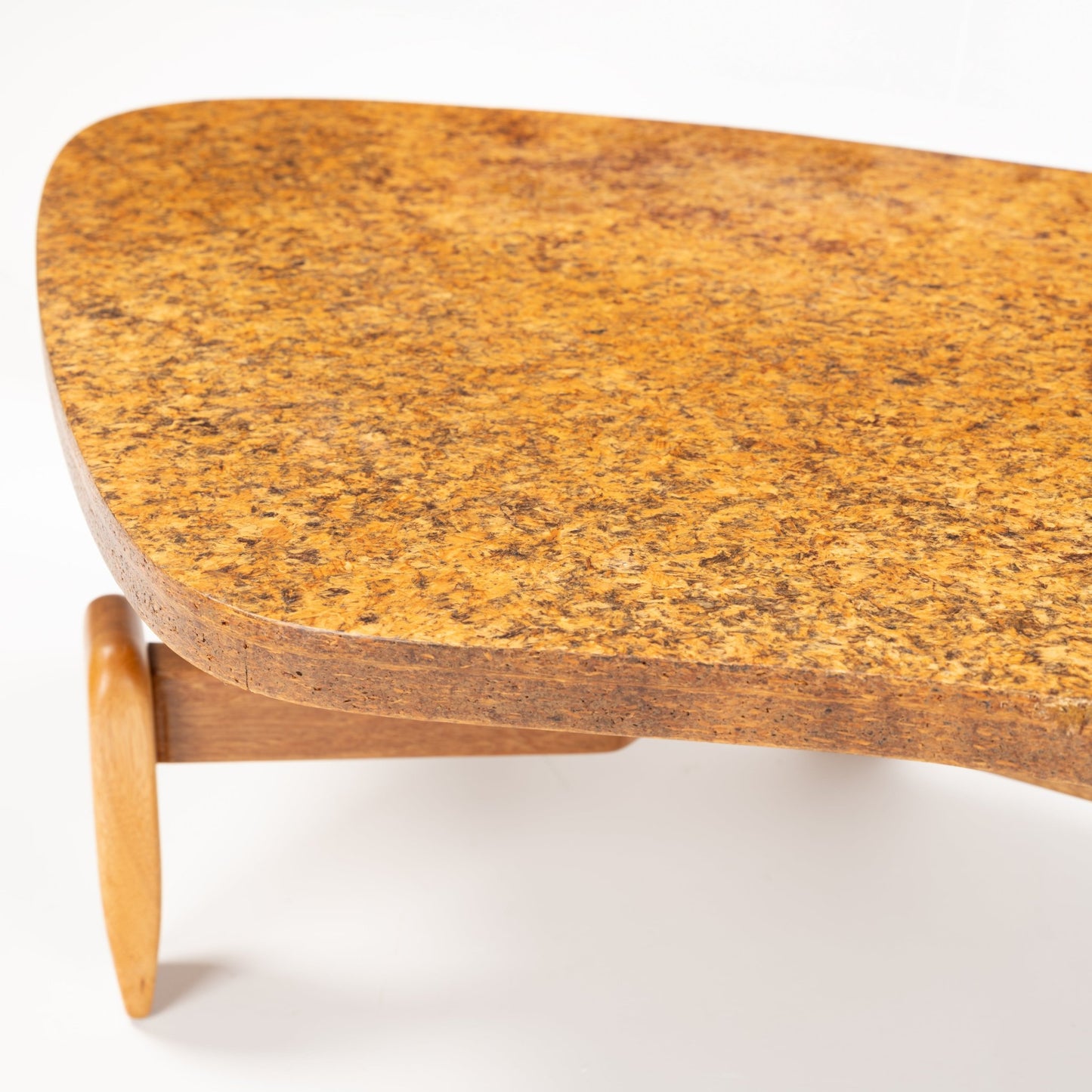 John Keal 'Outrigger' Coffee Table featuring a thick, warm cork top with rich, naturally mottled texture supported by a sculptural wooden leg, showcasing mid century modern style.