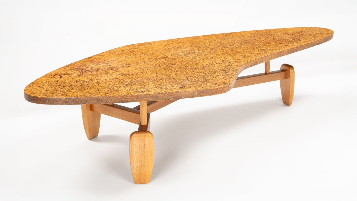 John Keal 'Outrigger' Coffee Table showcasing an asymmetrical cork top with warm natural texture, supported by sculptural wooden legs in a mid century modern style.