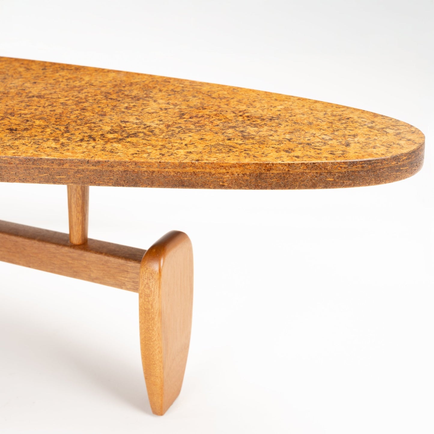 John Keal 'Outrigger' Coffee Table with an organic-shaped cork top featuring a warm, mottled texture, supported by a sculptural wooden base with delicately tapered legs, exemplifying mid century modern furniture.