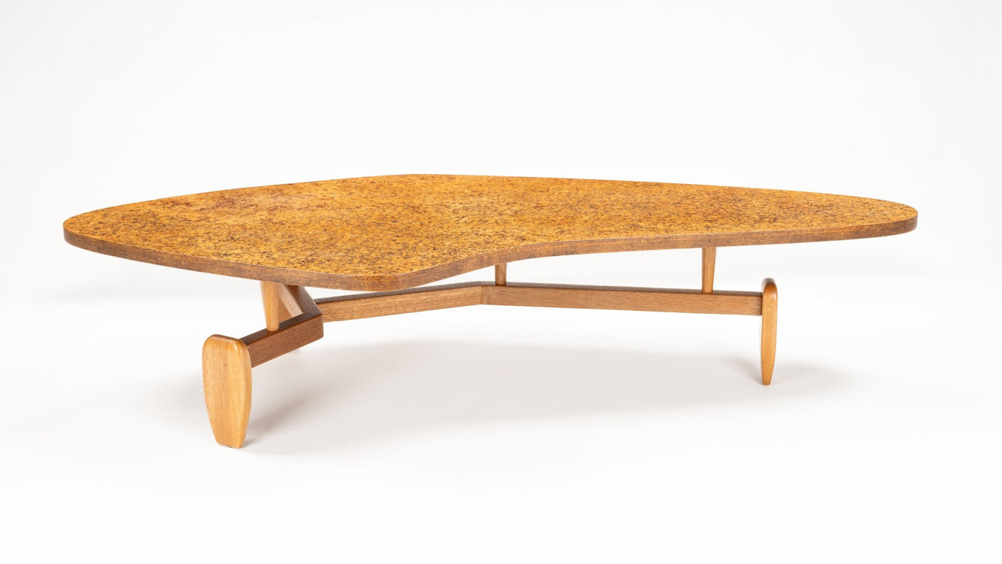 John Keal 'Outrigger' Coffee Table with a unique organic-shaped cork tabletop resting on a sculptural wooden base with three tapered legs, showcasing mid century modern design.