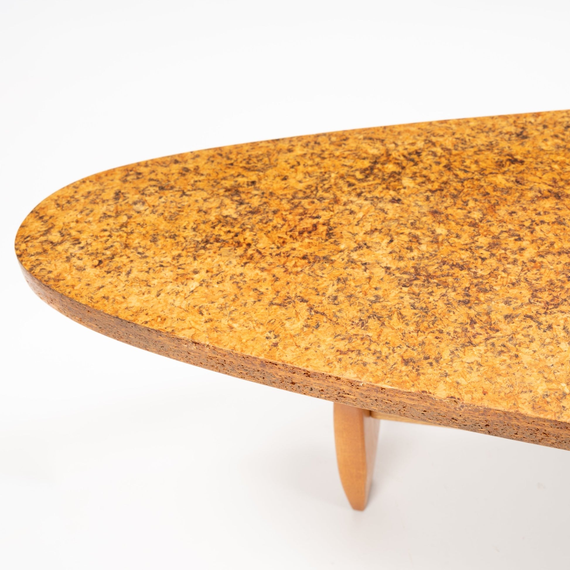 John Keal 'Outrigger' Coffee Table close-up showing the warm-hued, textured cork tabletop with a gently tapered wooden leg, highlighting elegant mid century modern craftsmanship.