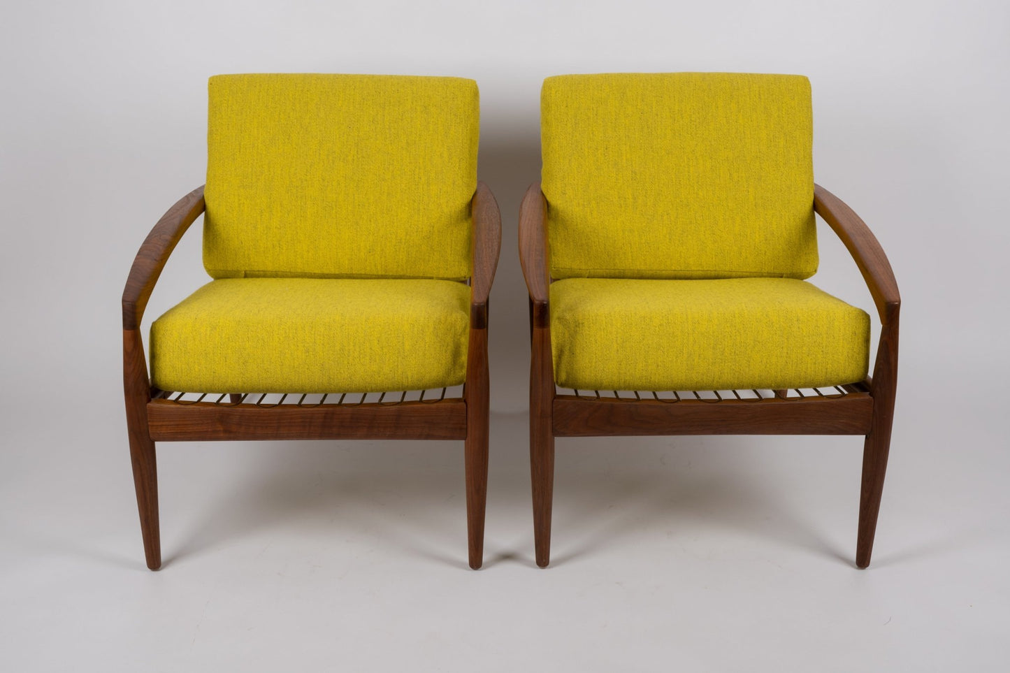 Pair of 1960s Kai Kristiansen 'Paper Knife' chairs in solid teak with slatted seats and yellow cushions from Denmark