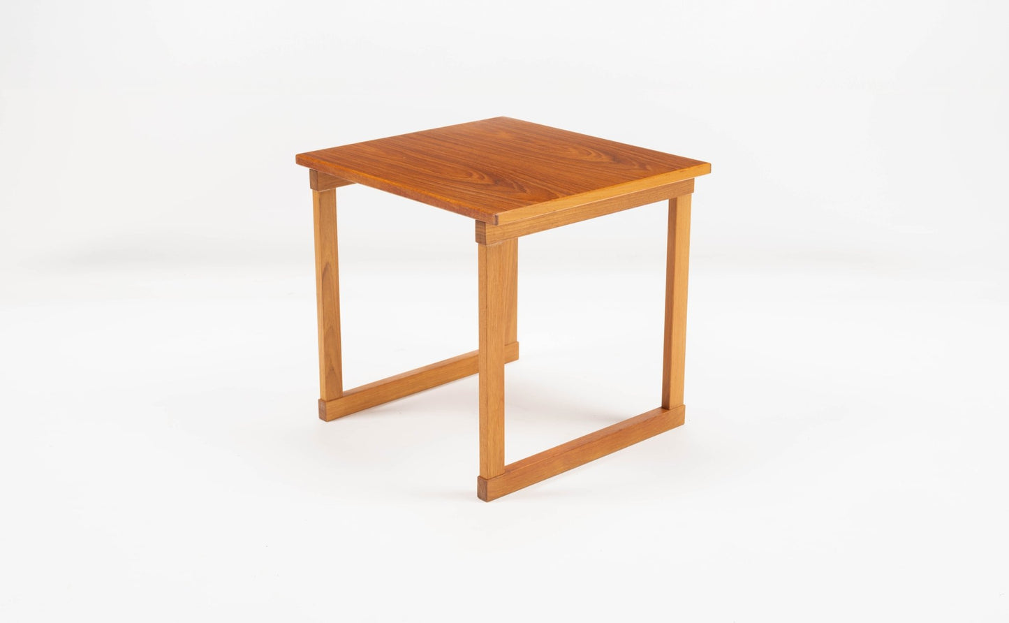 Mid-century modern teak side table with square top and open frame legs designed by Kai Kristiansen.