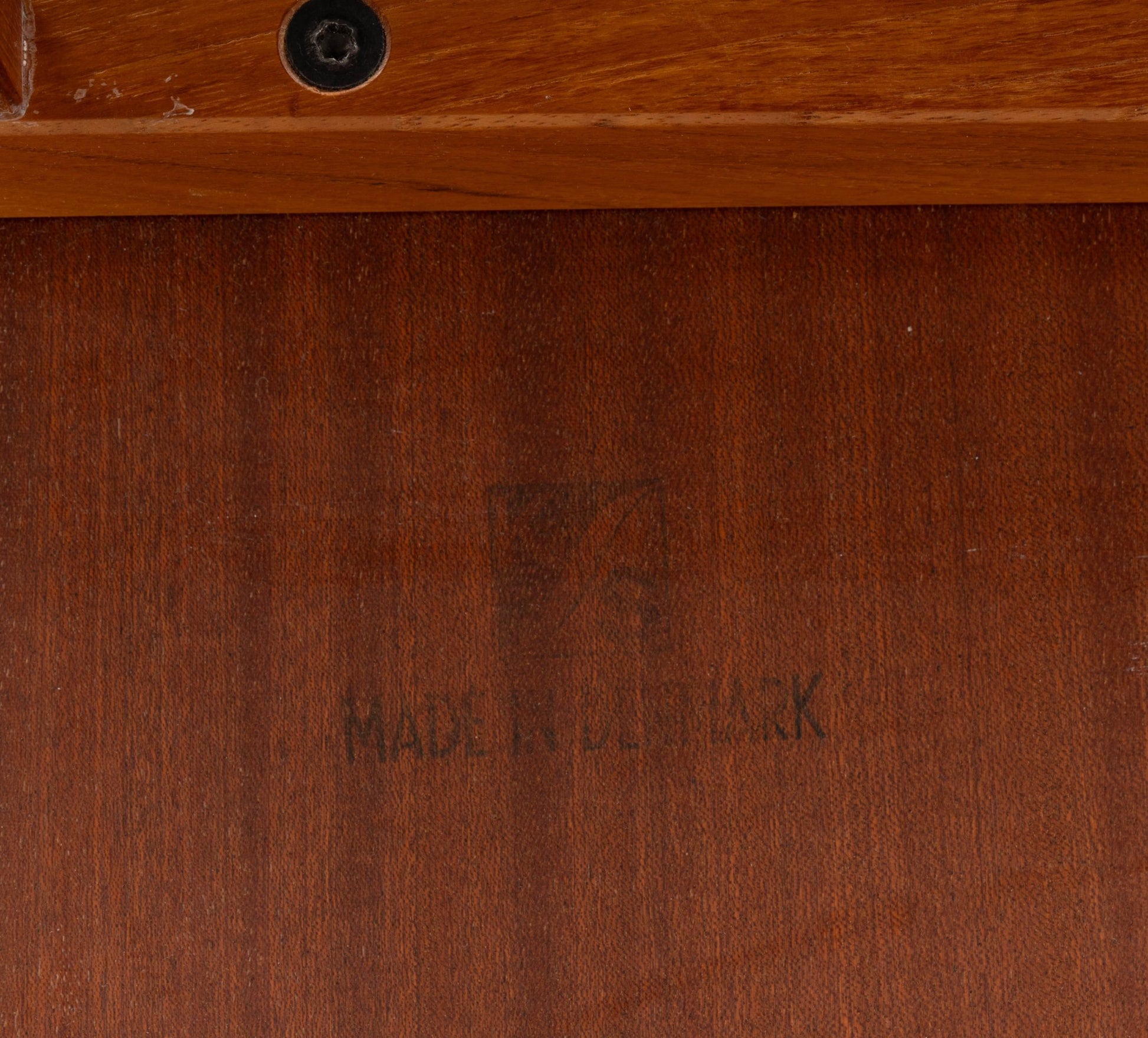 Close-up of "Made in Denmark" mark on teak wood surface of Kai Kristiansen "The Cube" interlocking side table.