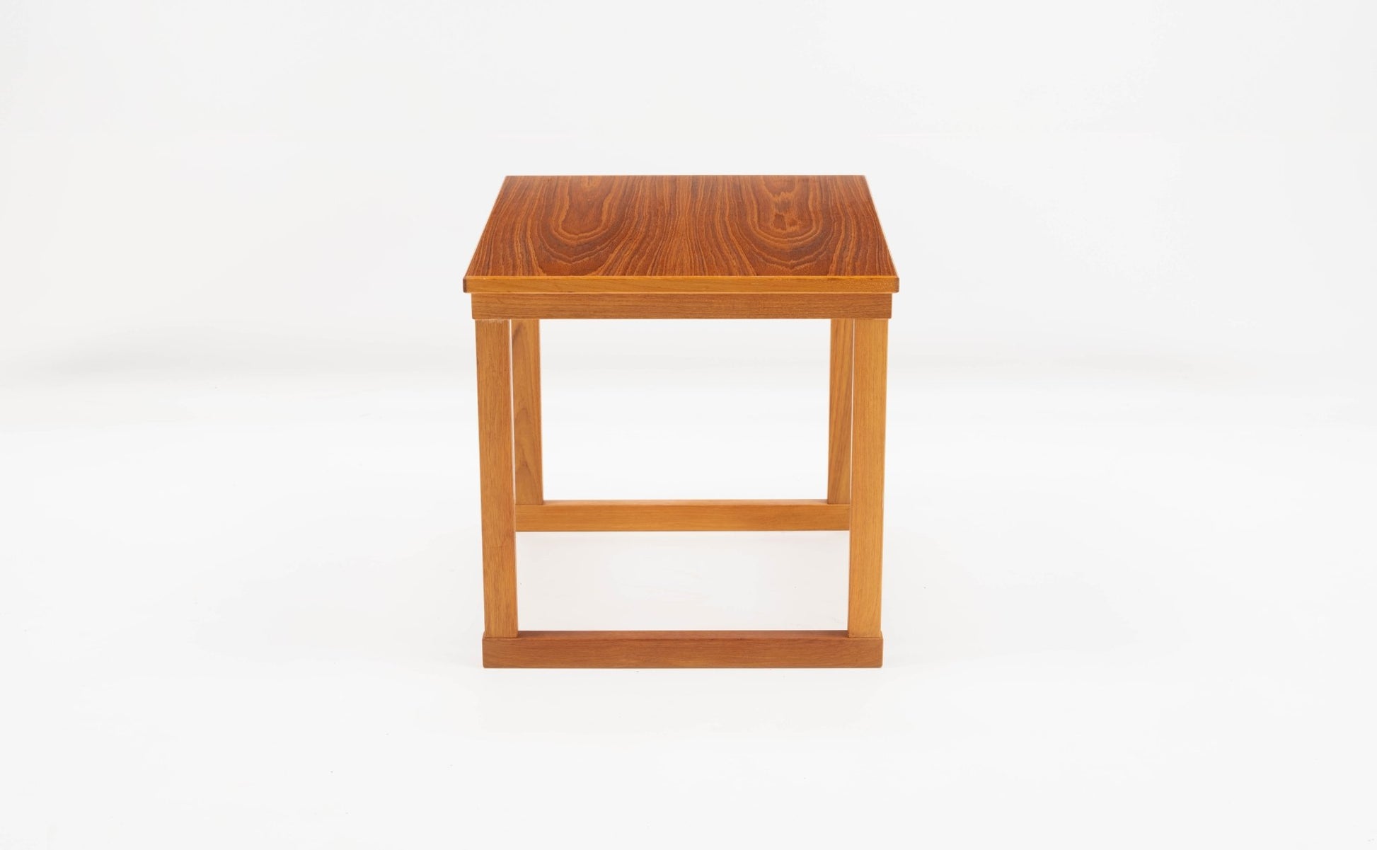 Mid-century modern teak side table by Kai Kristiansen, geometric cube design with clean lines on white background.