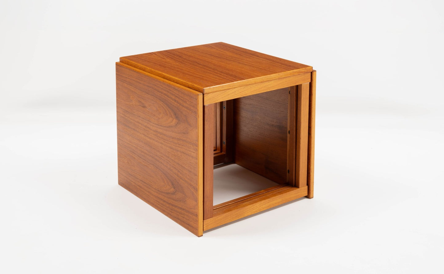 Mid-century modern teak cube side table designed by Kai Kristiansen with interlocking modular design on white background