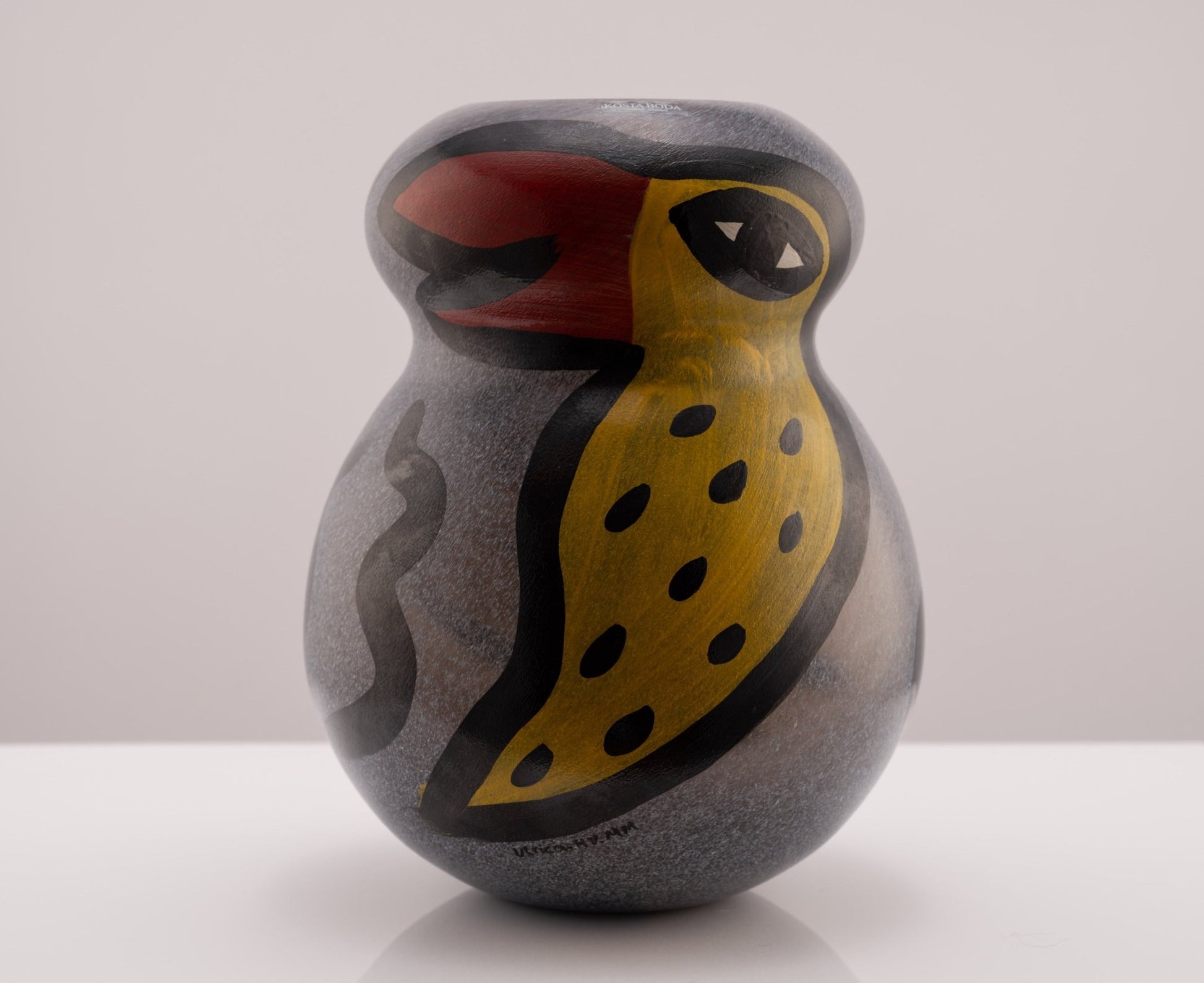 Kosta Boda Birdy Vase by Ulrica Hydman-Vallien featuring colorful bird and worm motifs with a clear opening for light.