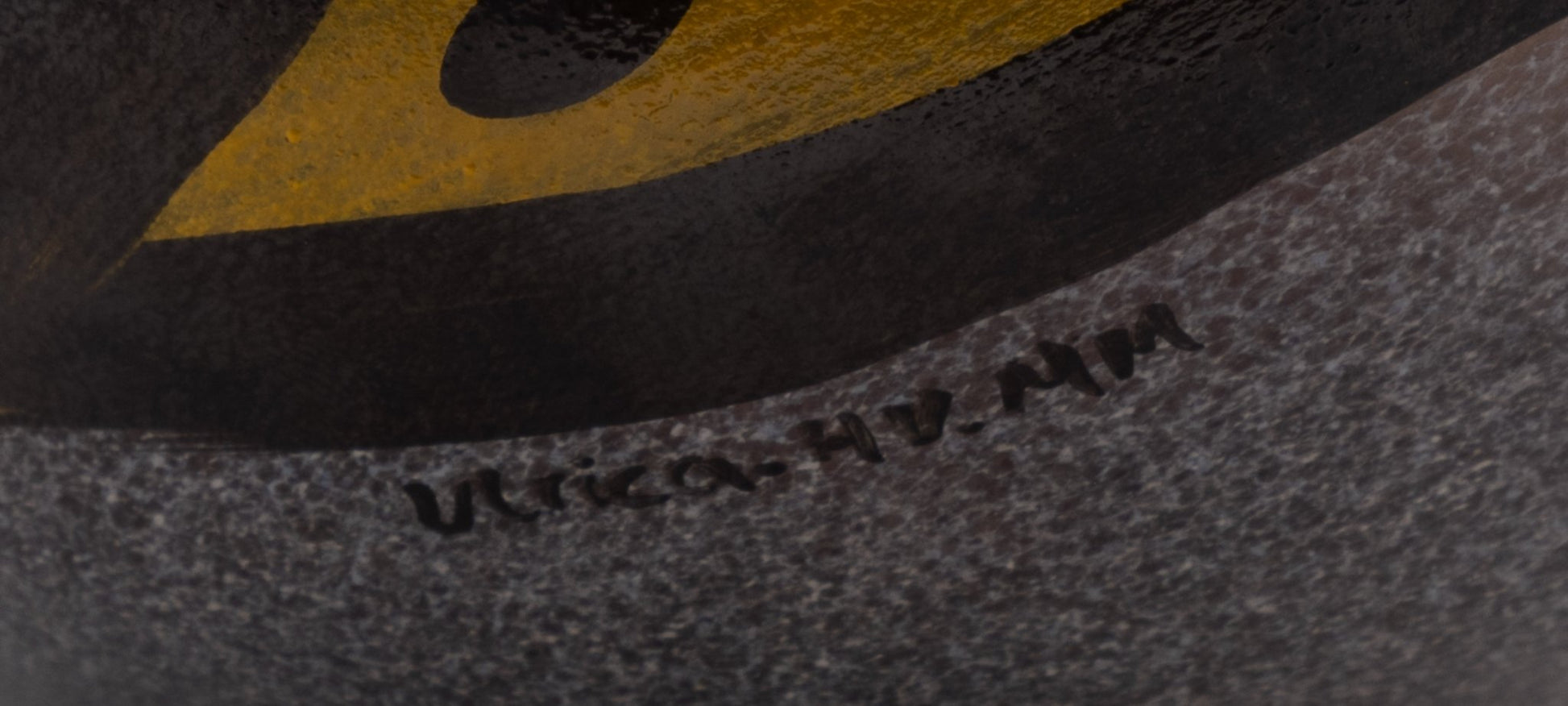 Close-up of Ulrica Hydman-Vallien signature on Kosta Boda Birdy Vase with textured glass surface and painted design