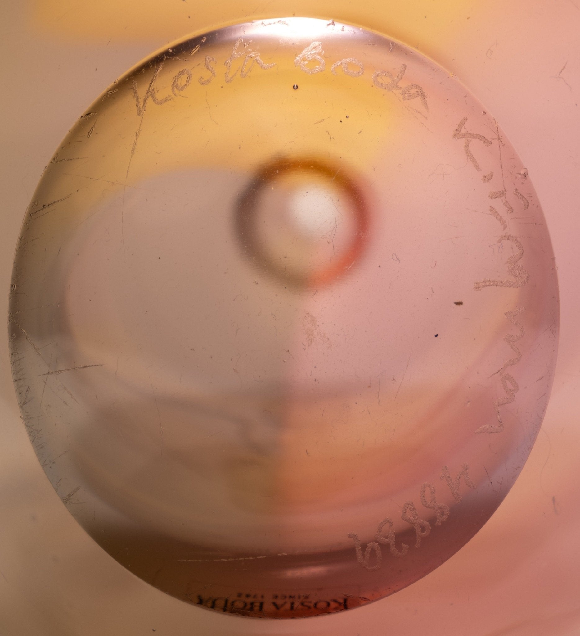 Close-up of the base of Kosta Boda Fidji glass bottle signed by Kjell Engman with artist collection inscription