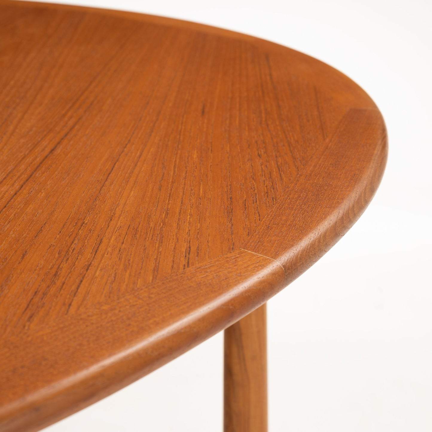 Kurt Ostervig Drop-Leaf Dining Table close up of rounded walnut edge and tapered wooden leg showing polished grain in mid century modern furniture style