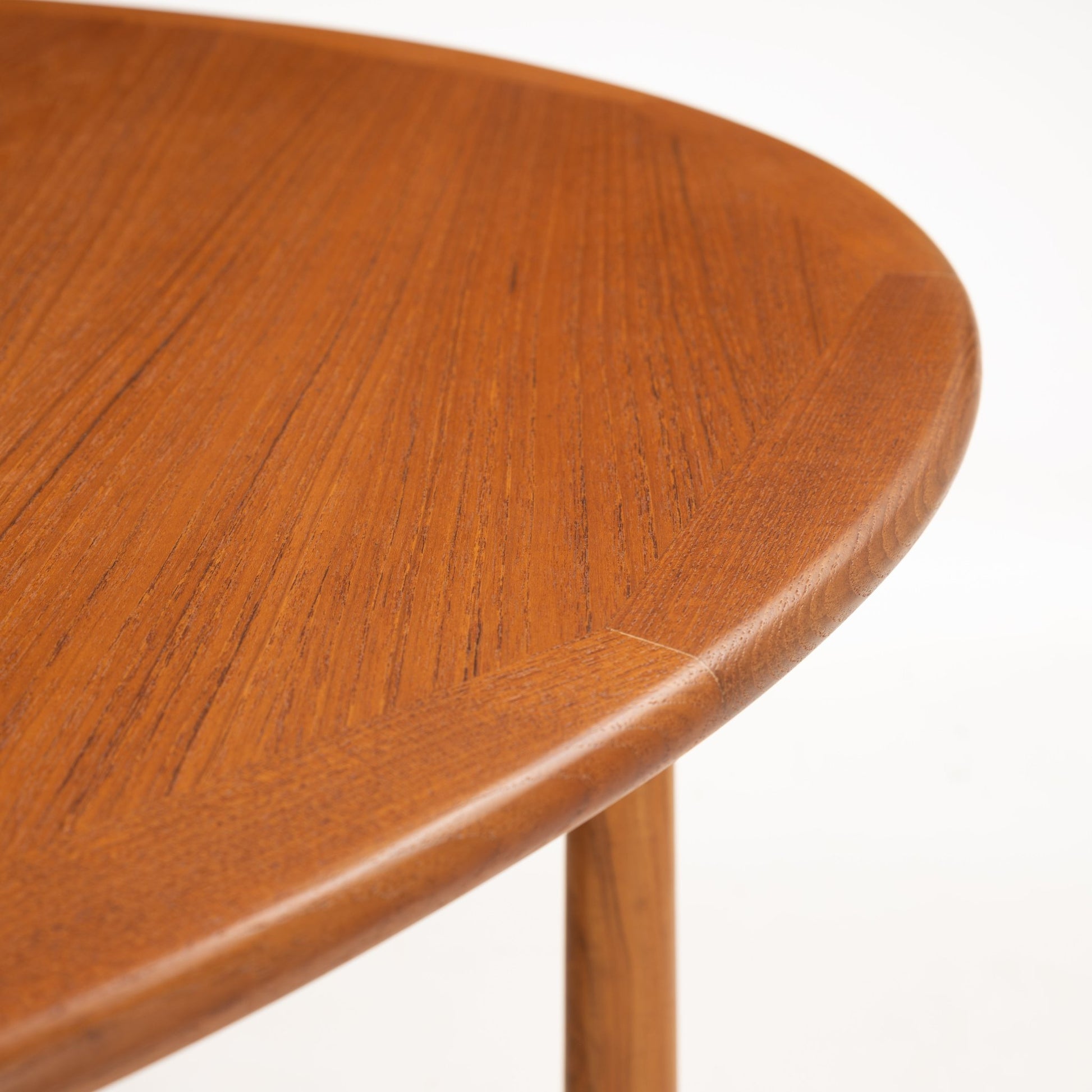 Kurt Ostervig Drop-Leaf Dining Table close up of rounded walnut edge and tapered wooden leg showing polished grain in mid century modern furniture style