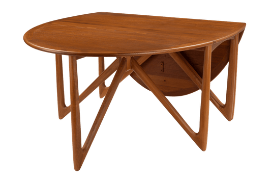 Kurt Ostervig Drop-Leaf Dining Table with rounded wood top sculptural angled legs folded drop leaves and warm mid century modern furniture styling