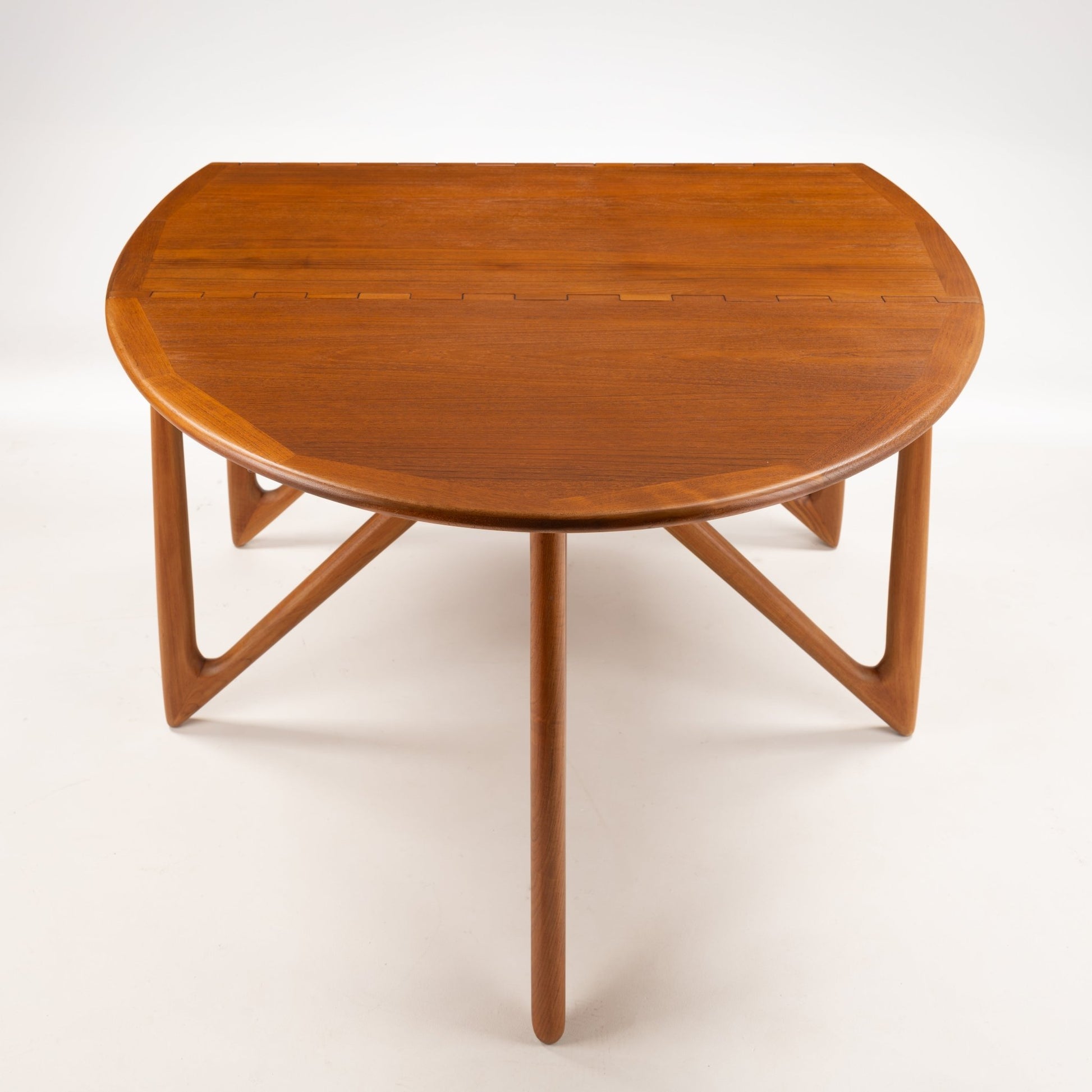 Kurt Ostervig Drop-Leaf Dining Table with closed walnut top and sculptural angled legs showcasing rich grain in mid century modern furniture style