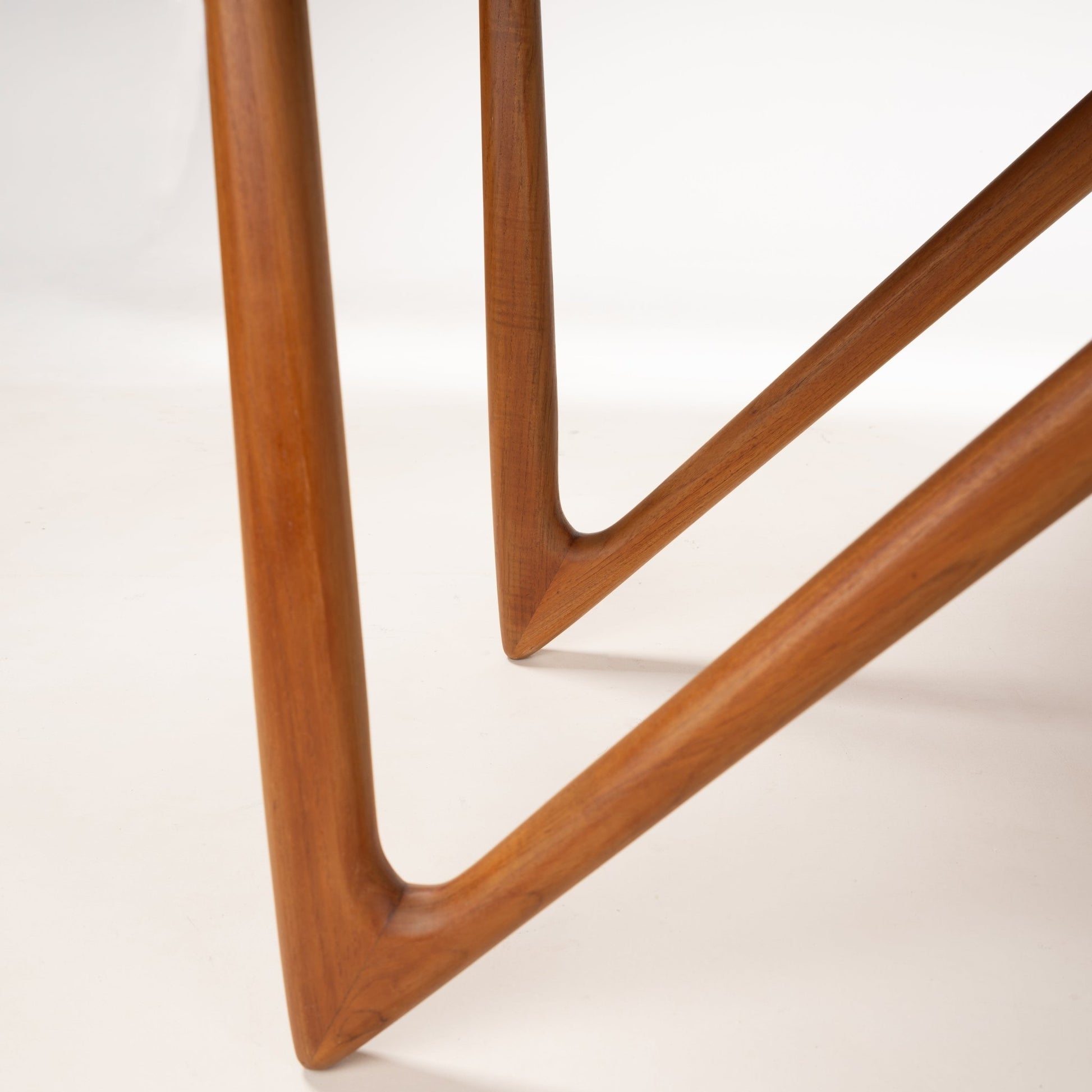 Kurt Ostervig Drop-Leaf Dining Table close view of sculptural angled wooden legs with warm polished grain and curved joinery in mid century modern furniture style