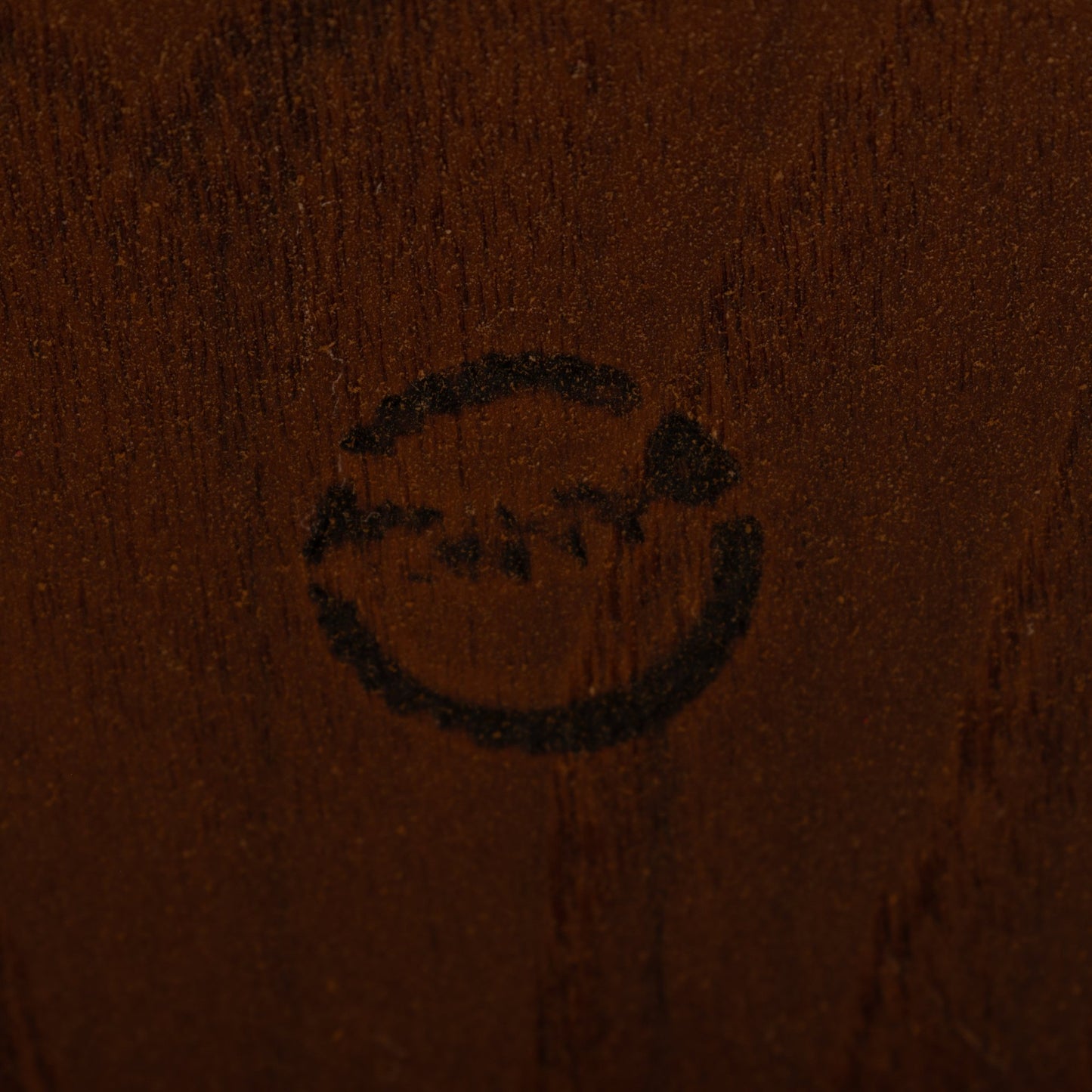 Kurt Ostervig Drop-Leaf Dining Table close detail of dark walnut grain and subtle circular maker mark showcasing vintage Danish furniture craftsmanship