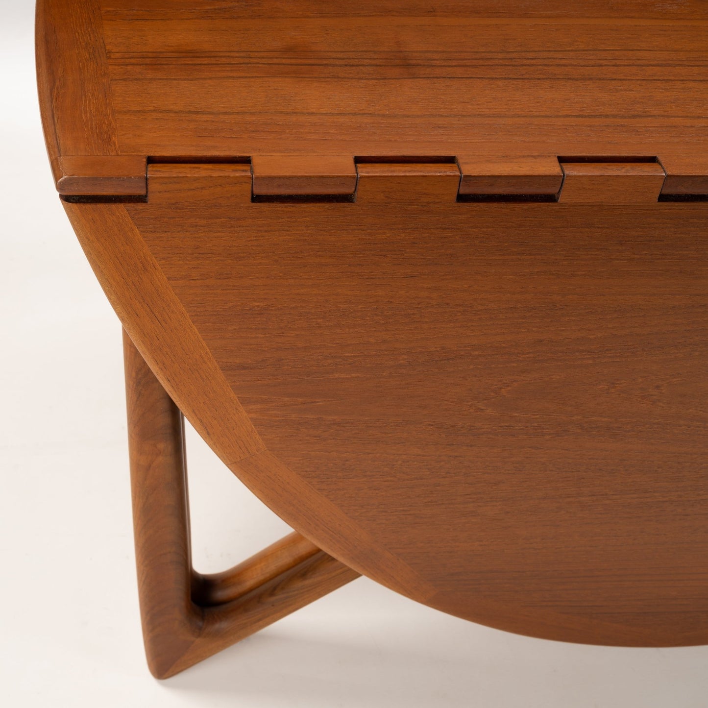 Kurt Ostervig Drop-Leaf Dining Table close up of walnut edge brass hinges and sculptural angled support leg in vintage Danish furniture style
