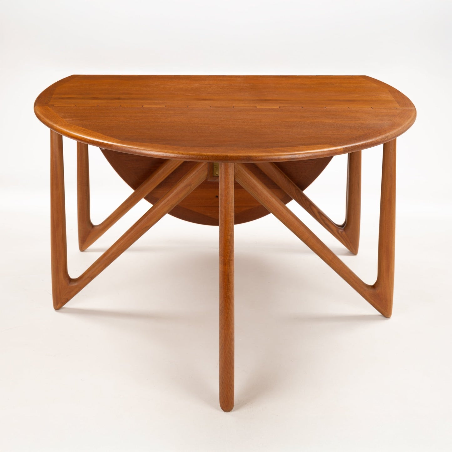 Kurt Ostervig Drop-Leaf Dining Table with oval walnut top folded leaves and sculptural angled legs showcasing rich grain in mid century modern furniture style