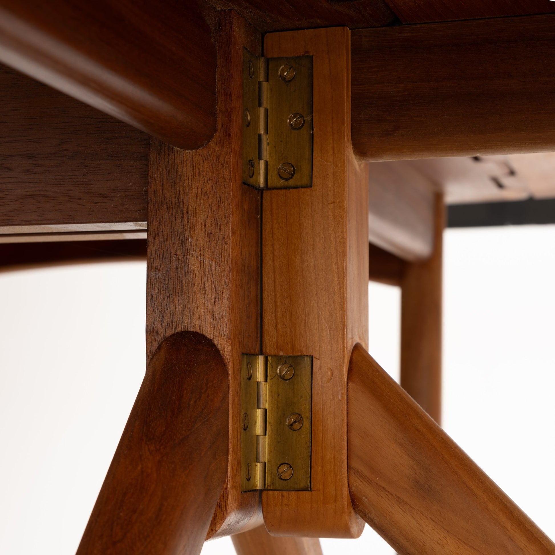 Kurt Ostervig Drop-Leaf Dining Table close detail of brass hinges and angled walnut support legs showing precise leaf joinery in vintage danish furniture style