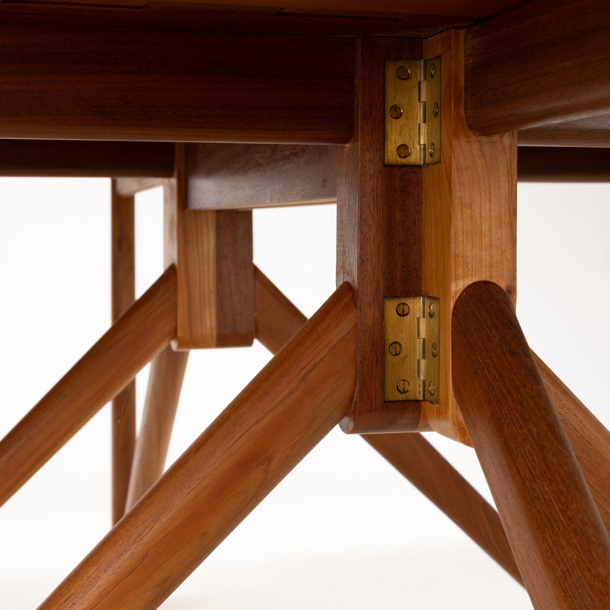 Kurt Ostervig Drop-Leaf Dining Table underside detail showing brass hinges angled wooden supports and rich walnut grain in mid century modern furniture style