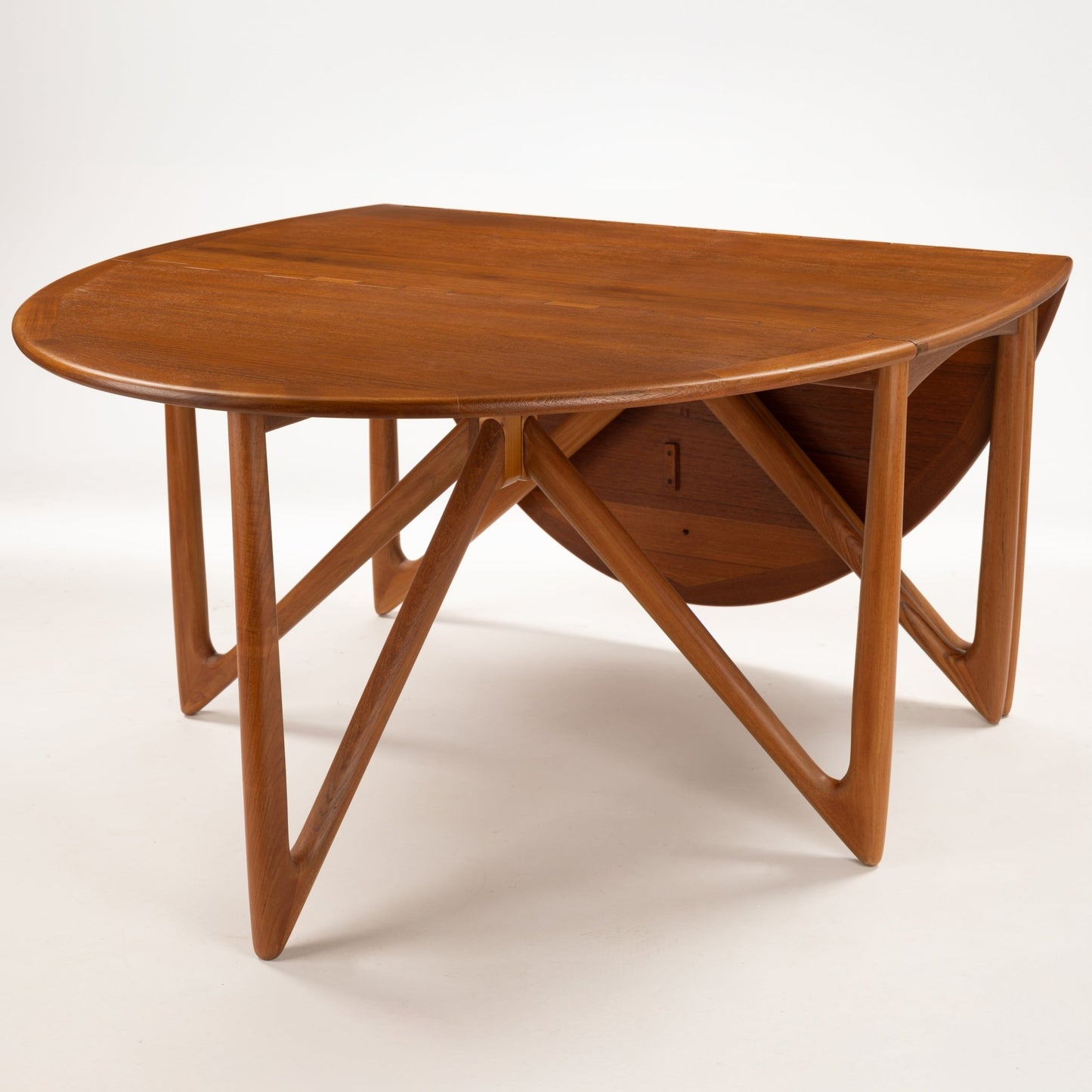 Kurt Ostervig Drop-Leaf Dining Table with oval wood top angled legs folded leaves and rich warm grain in mid century modern furniture style