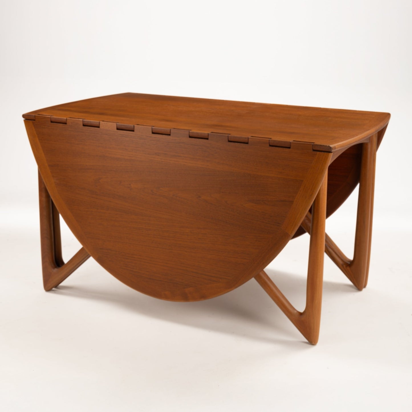 Kurt Ostervig Drop-Leaf Dining Table with folded leaves sculptural angled legs and rich warm wood grain in mid century modern furniture style