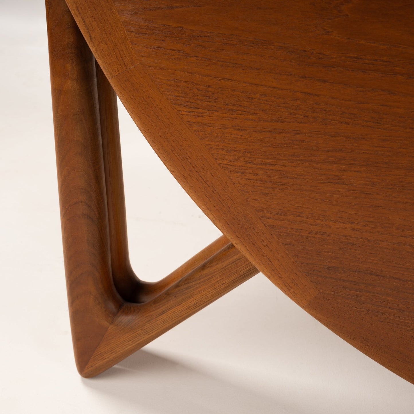Kurt Ostervig Drop-Leaf Dining Table close detail of curved walnut apron and sculptural angled leg showcasing rich grain in mid century modern furniture style